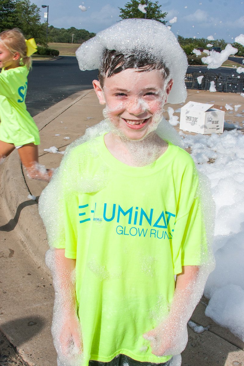 Tatum Vining of Hot Springs, the son of Jennifer Vining, co-founder of The Eternity Foundation, practices running through the foam that will blanket the course at the upcoming E-Luminate Glow Run & Citizen Way Concert, which will benefit several organizations in memory of Jennifer’s brother, Zeke Blanton.