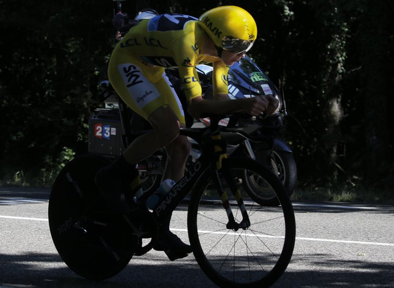 Britain's Chris Froome, wearing the overall leader's yellow jersey, rides during the thirteenth stage of the Tour de France cycling race, an individual time trial over 37.5 kilometers (23 miles) with start in Bourg-Saint-Andeol and finish in La Caverne du Pont-d'Arc, France, Friday, July 15, 2016. 