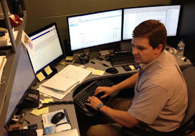 Jonesboro police detective Brandon King monitors screens used in the department’s Internet Crimes Against Children laboratory to track Web addresses of people who download child pornography. 