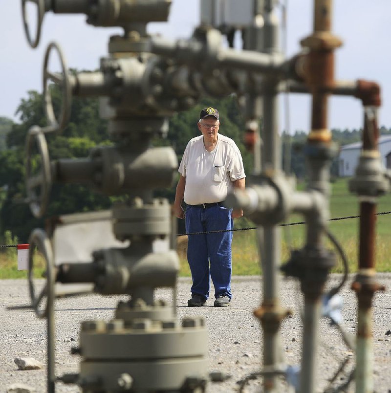 Verlon Abram stands near one of the many natural-gas wells on his property in Cleburne County. Though his royalty checks are shrinking, “the gas companies were good to me,” Abram says.