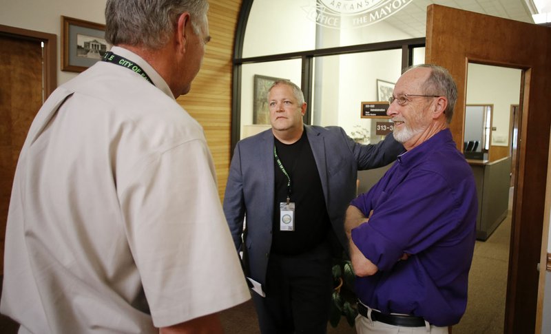 Don Marr (center), chief of staff for Fayetteville, and Mayor Lioneld Jordan (right) speak Tuesday following an agenda-setting meeting at City Hall.