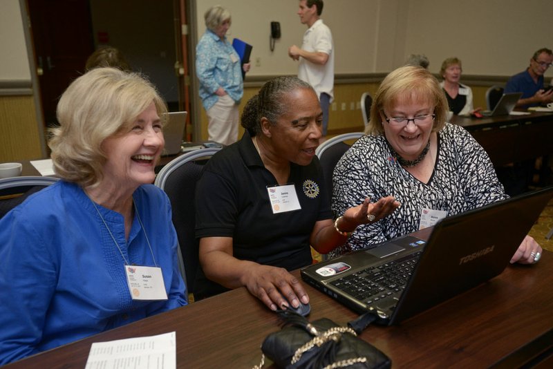 Susan Hays (from left) of Jackson, Tenn., Janine Coleman of Lafayette, La., and Ronna Morse of Valentine, Neb., work together in a breakout session on how to use the Rotary Youth Exchange Data System, or RYEDS, database on Saturday during the annual South Central Rotary Youth Exchange conference hosted by the Rotary Club of Bentonville at the Four Points by Sheraton in, Bentonville. The conference was an opportunity for Rotarians to learn how to help with the club’s international student exchange program.
