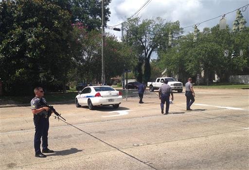 Baton Rouge police officers man a roadblock at Old Hammond Highway and Tara Boulevard after multiple officers were shot Sunday in Baton Rouge, La. 


