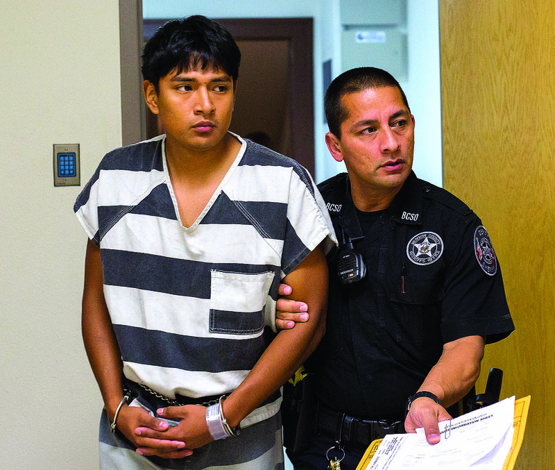 Edward Alexis Martinez-Torres is led from Circuit Judge Robin Green’s courtroom on June 20 at the Benton County Courthouse in Bentonville. Accused of killing a 3-month-old boy, Martinez-Torres had his bond set at $500,000.