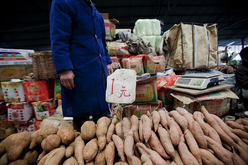 Sweet potatoes are for sale at a market in Beijing in this file photo. China’s farmers produced 77.7 million tons of sweet potatoes in 2013, more than 20 times any other country.