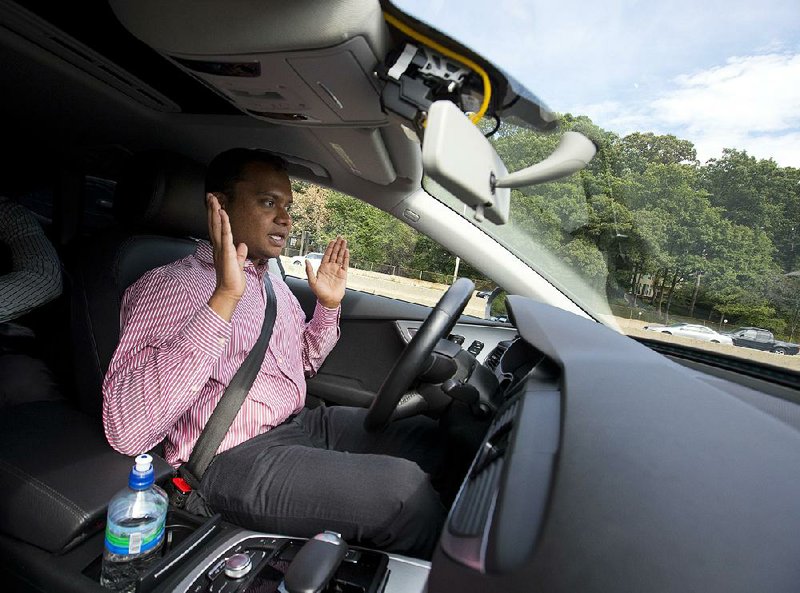 Kaushik Raghu, senior staff engineer at Audi, demonstrates an Audi self-driving vehicle on an interstate in Virginia on Friday. Automakers are developing automated systems that can operate cars in some or most circumstances, but they still require a driver’s attention. 