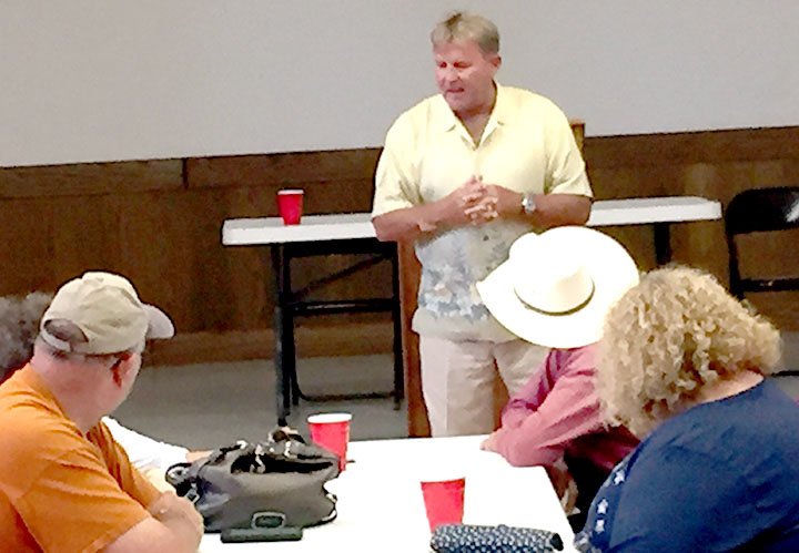 Submitted Photo Jay Mitchell (standing), the owner of Ark-O Holding, addressed questions from Decatur residents concerning their phone and Internet services during a town meeting in the community room at Decatur City Hall on July 1. Ark-O took over control of the local telephone service from TDS Telecom Dec. 17, 2015.