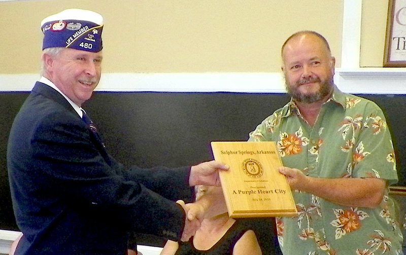 By Larry Burge Mayor Greg Barber (right) receives a plaque from senior vice commander Chuck Adkins, Jr., designating Sulphur Springs as the state&#x2019;s 30th Purple Heart City.
