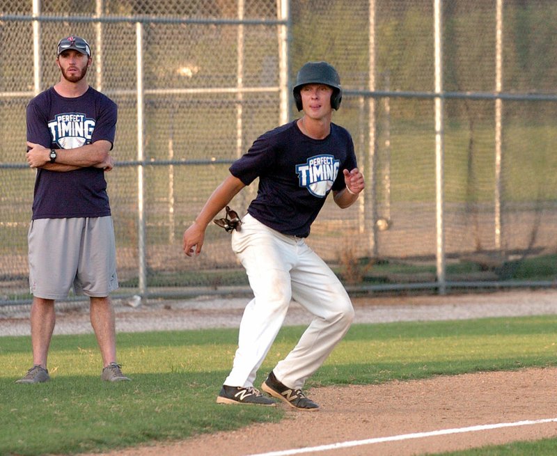 MIKE CAPSHAW ENTERPRISE-LEADER Perfect Timing coach Matt Vinson watches as Gavin Heltemes leads off of third base during the Perfect Timing Collegiate League All-Star Game at Veterans Park in Rogers on Monday, July 18. Heltemes reached on a fielder&#8217;s choice and scored a run during the third inning of his team&#8217;s 5-0 victory.