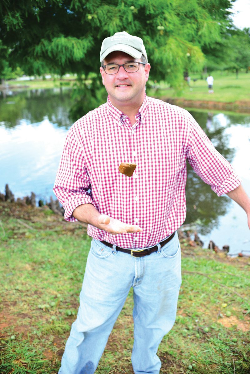 John Baker, a Little Rock attorney, tosses a stone that he thinks is good for skipping. Baker, who grew up skipping rocks and enjoys the activity with his four children, as well as his brother, created the Great Southern Stone-Skipping Championship, scheduled for Sept. 3 on Greers Ferry Lake in Fairfield Bay. Baker has a summer home in the community.