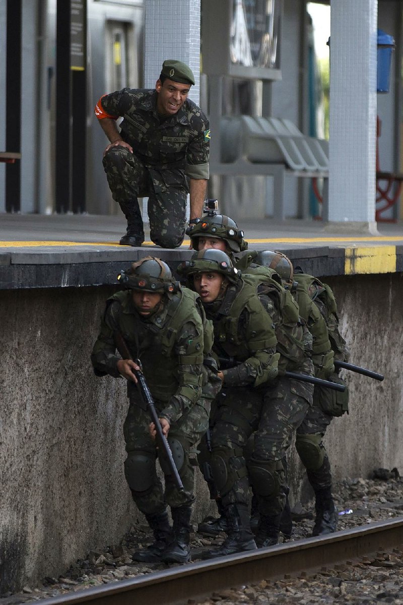 Soldiers took part Saturday in a security training drill simulating a terrorist attack at the Deodoro train station in Rio de Janeiro. A poll by Brazil’s Datafolha Polling Institute found 63 percent of Brazilians polled think next month’s Olympics will bring more harm than good.