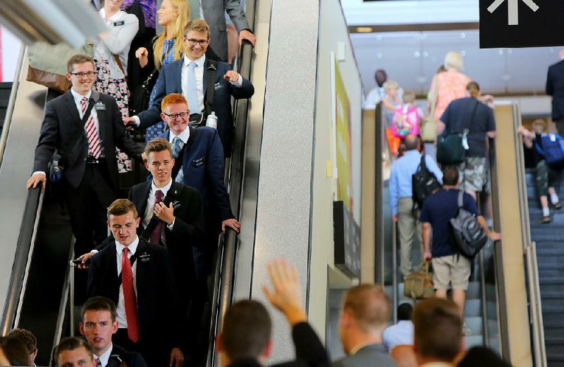 Missionaries from The Church of Jesus Christ of Latter-day Saints arrive Tuesday at Bill and Hillary Clinton National Airport/Adams Field in Little Rock.
