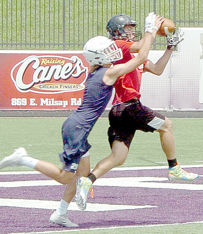 McDonald County wide receiver Cole DelosSantos catches a touchdown pass from Shiloh Jackson against Bentonville West at a 7-on-7 camp at Fayetteville High School on July 14.