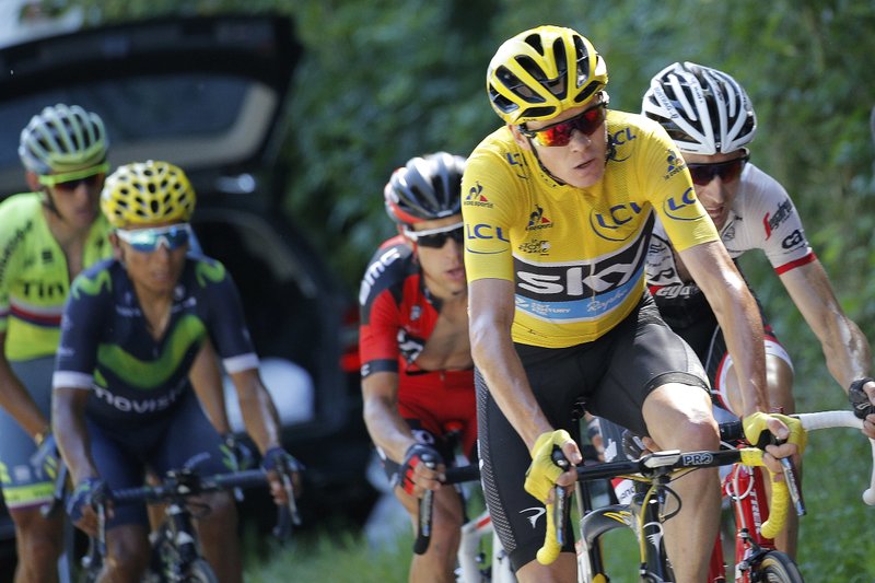 Britain's Chris Froome, wearing the overall leader's yellow jersey, Australia's Richie Porte, in red, and Netherlands' Bauke Mollema, right, break away from Colombia's Nairo Quintana, rear, during the seventeenth stage of the Tour de France cycling race over 184.5 kilometers (114.3 miles) with start in Bern and finish in Finhaut-Emosson, Switzerland, Wednesday, July 20, 2016. 