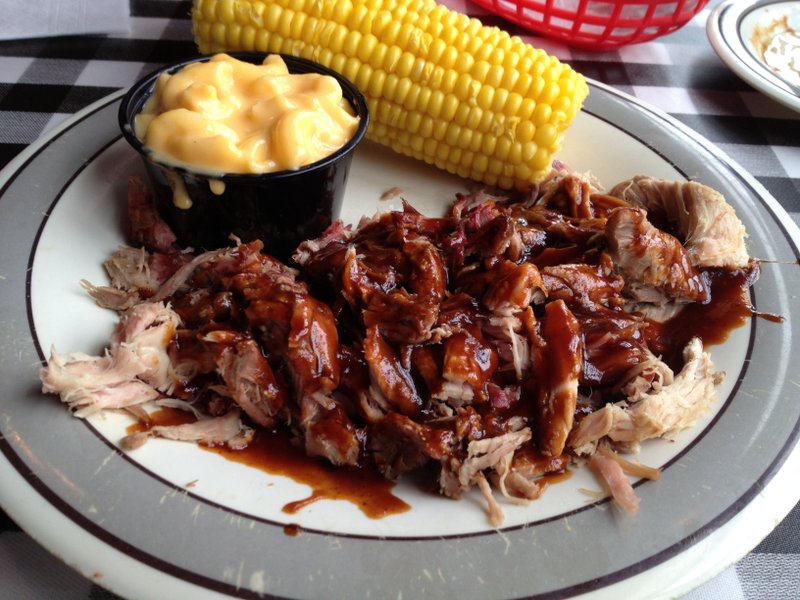 A pulled pork platter is served with mac & cheese and corn on the side at the west Little Rock Corky’s Ribs & BBQ.