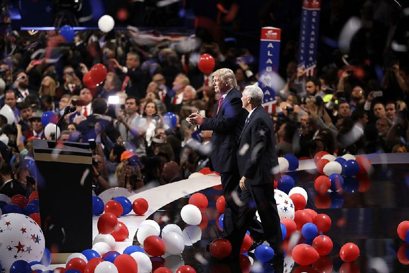 Donald Trump and running mate Mike Pence celebrate with the crowd Thursday night in Cleveland after Trump’s speech accepting the Republican nomination for president.