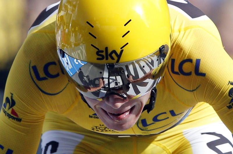 Britain's Chris Froome, wearing the overall leader's yellow jersey crosses the finish line to win the eighteenth stage of the Tour de France cycling race, an individual time trial over 17 kilometers (10.6 miles) with start in Sallanches and finish in Megeve, France, Thursday, July 21, 2016. 