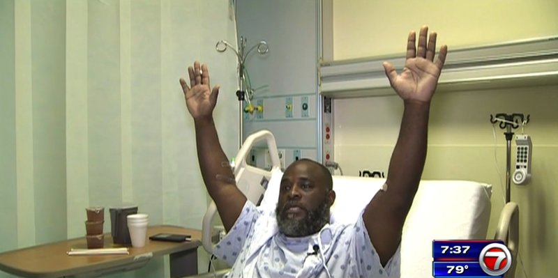 In this Wednesday, July 20, 2016, frame from video, Charles Kinsey explains in an interview from his hospital bed in Miami what happened when he was shot by police on Monday. Kinsey, a therapist who was trying to calm an autistic patient in the middle of the street, said he was shot even though he had his hands in the air and repeatedly told the police that no one was armed. 