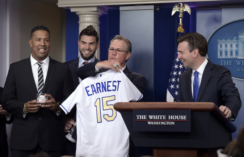 The Associated Press HONORARY ROYAL: Kansas City Royals manager Ned Yost holds up a jersey that the team presents Thursday to White House press secretary Josh Earnest, right, a Kansas City, Mo., native and Royals fan. Also pictured are Royals team members Salvador Perez, left, and Eric Hosmer. The Royals defeated the New York Mets in five games last year for the fracnchise's first World Series title since 1985.