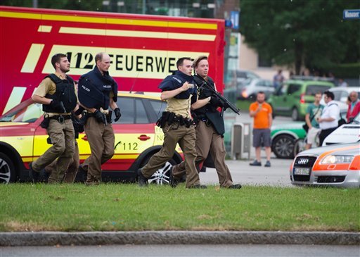 Policemen arrive at a shopping center at which a shooting was reported in Munich, southern Germany, on Friday, July 22, 2016. 