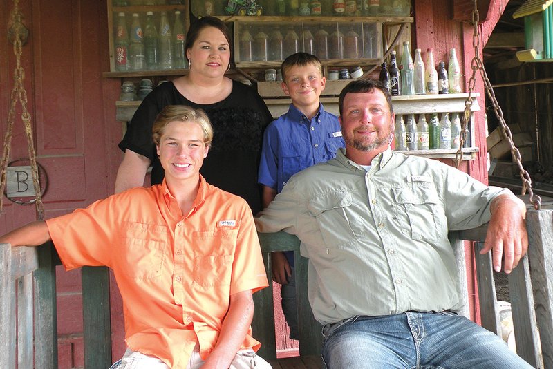 The Brad Burkett family of McCrory is the 2016 Woodruff County Farm Family of the Year. Family members are, seated, Garrett, left, and Brad Burkett; and standing, Angie, left, and Gavin Burkett. The family raises rice, corn and soybeans.