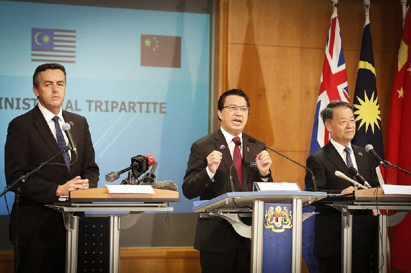 Transport ministers (from left) Darren Chester of Australia, Liow Tiong Lai of Malaysia and Yan Chuantang of China announce Friday in Putrajaya, Malaysia, plans to suspend the search for Malaysian Airlines Flight 370 once an area of the Indian Ocean is scoured.