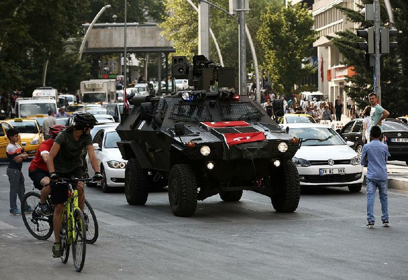 A police vehicle joins the traffic Friday in Ankara, Turkey. The country is under a three-month state of emergency