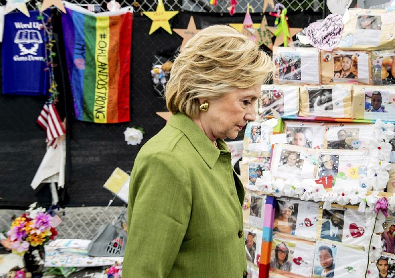 Hillary Clinton visits a memorial to victims of the Pulse nightclub shooting in Orlando, Fla., on Friday before she
announced Sen. Tim Kaine, D-Va., as her running mate.