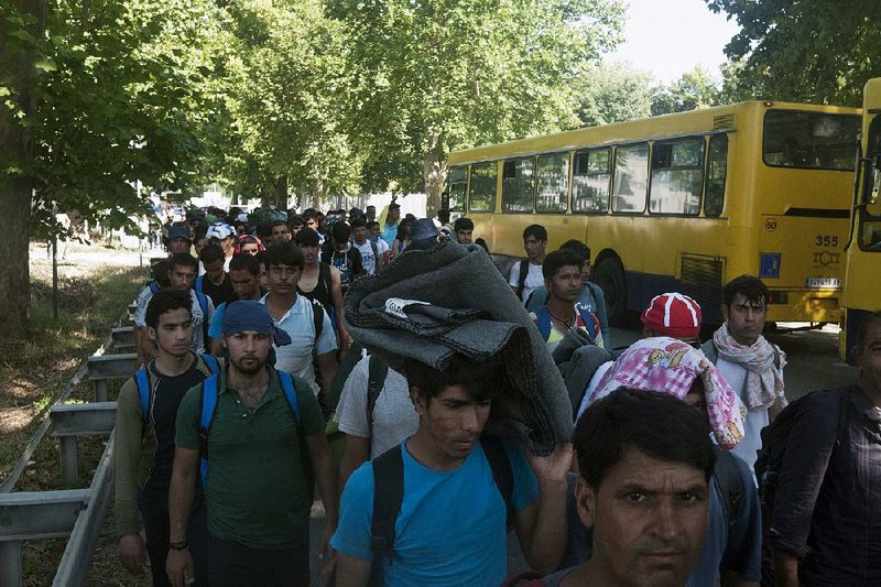 Migrants march Friday on the outskirts of Belgrade, Serbia.