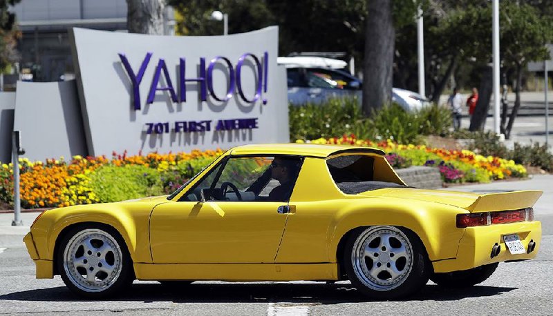 A motorist passes Yahoo’s headquarters Tuesday in Sunnyvale, Calif. An analyst said buying Yahoo would be a boon for Verizon.
