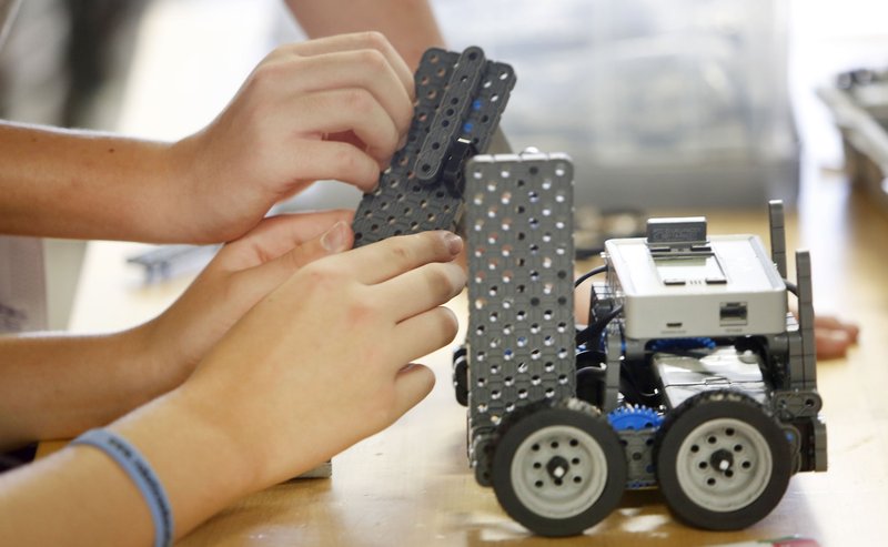 The hands of Ian Malloy, 13, and Judd Pleimann,12, are visible Wednesday, June 1, 2016, as they assemble parts in the Fayetteville Robotics Summer Camp at Fayetteville High School. The four day class uses the Vex IQ Robot platform.