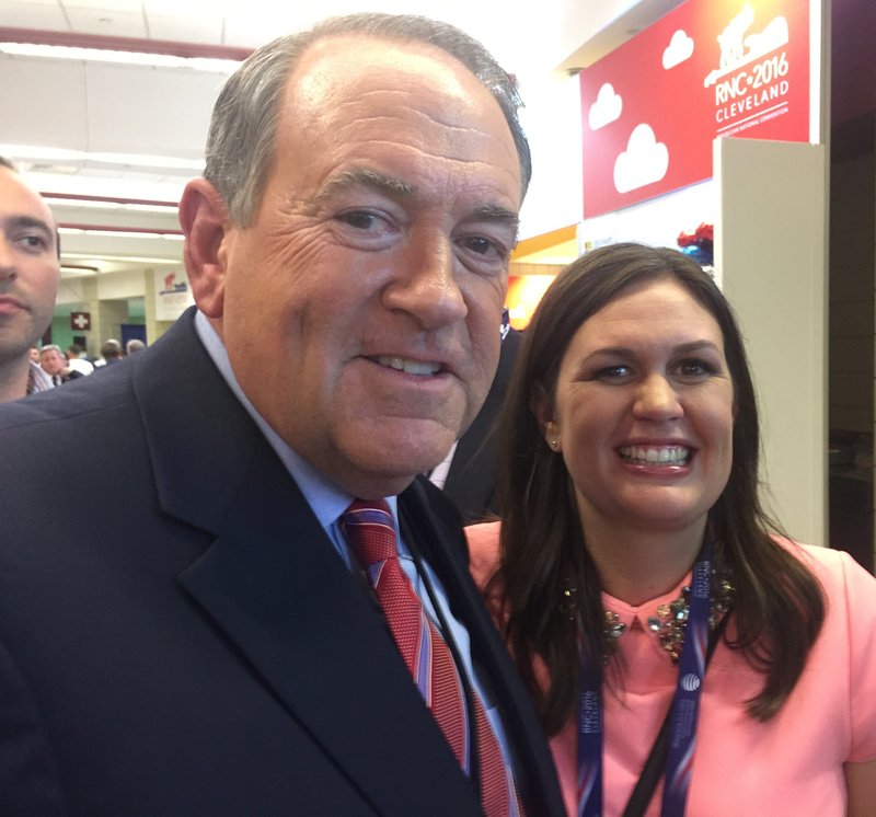Sarah Huckabee Sanders visits Tuesday with her father, Mike Huckabee, in a hallway of Quicken Loans Arena in Cleveland.