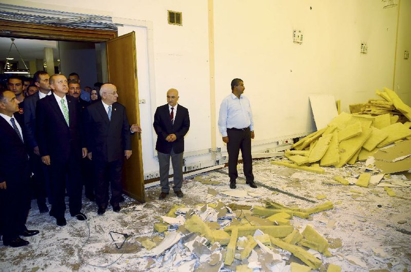 Turkish President Recep Tayyip Erdogan (second from left) tours the parliament building Friday in Ankara to see the damage left by fighting in a July 15 coup attempt.