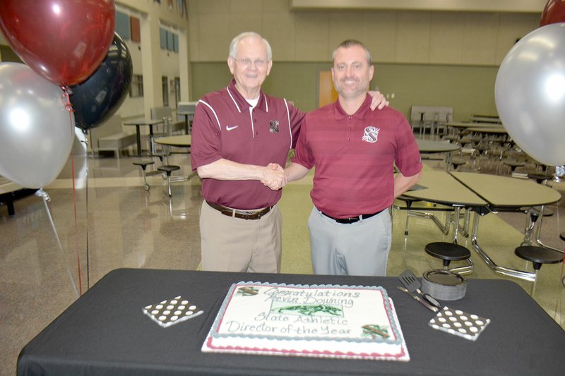 Graham Thomas/Siloam Sunday Siloam Springs athletics director Kevin Downing, right, was formally congratulated by Superintendent Ken Ramey during a luncheon held Friday for the Siloam Springs athletic department for being named the Athletic Director of the Year for Class 6A and the entire state of Arkansas. Downing was selected for this award by other state athletic directors.