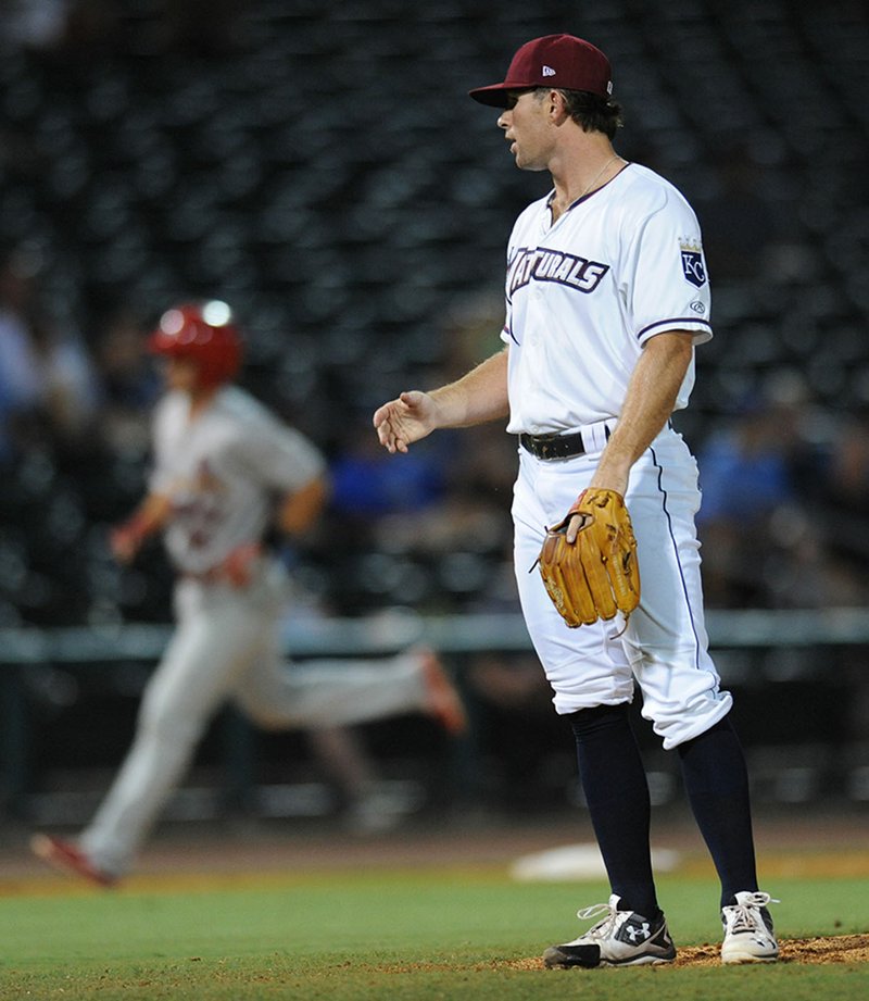 Northwest Arkansas Naturals reliever Reid Redman reacts Saturday as Springfield Cardinals third baseman rounds the bases after hitting a solo home run during the 10th inning at Arvest Ballpark in Springdale.
