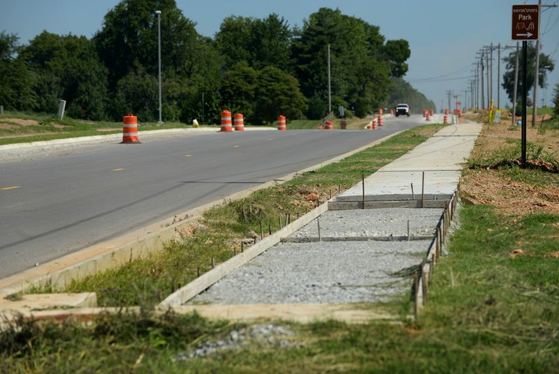 Work continues on Gamble Road Friday in front of Bentonville West High School in Centerton.