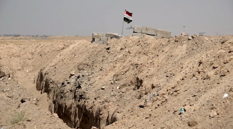 This image made from video on Friday, July 22, 2016, shows a trench on the outskirts of Fallujah, Iraq. Iraq&#x2019;s army is turning to a radical, almost medieval method to control Fallujah after recapturing it from the Islamic State group last month: It is digging a trench that will almost entirely encircle the city, aimed at preventing it from falling back into the hands of militants. (AP photo via AP video)