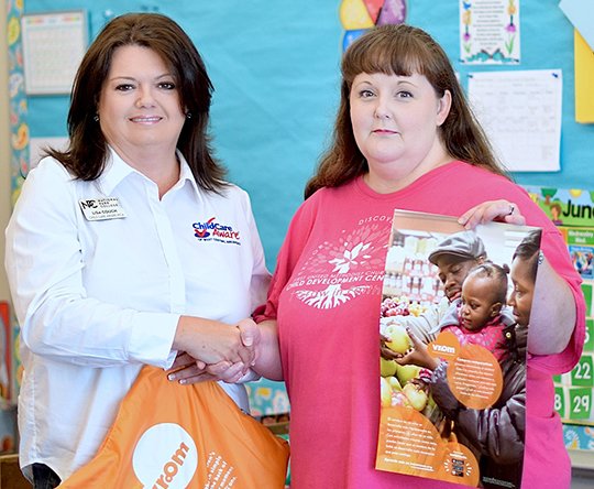 Submitted photo VROOM: Lisa Couch, Child Care Aware of West Central Arkansas program coordinator, shared a Vroom resource package with First United Methodist Church Child Development Center LesLee Jones. National Park College's CCAWCA was one of 10 sites in the country chosen to be part of Child Care Aware of America's Vroom initiative.