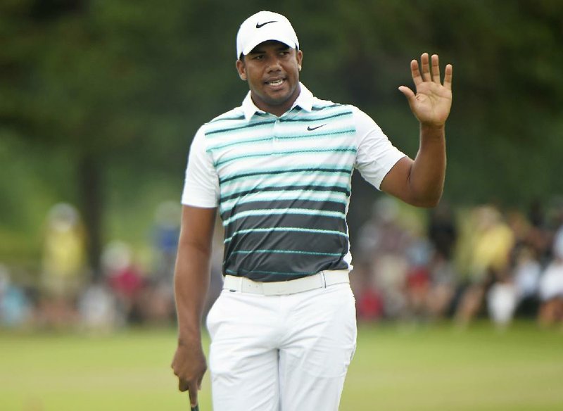 Jhonattan Vegas, of Venezuela, acknowledges the crowd on the 18th green during the final round at the Canadian Open golf tournament in Oakville, Ontario, Sunday, July 24, 2016. 