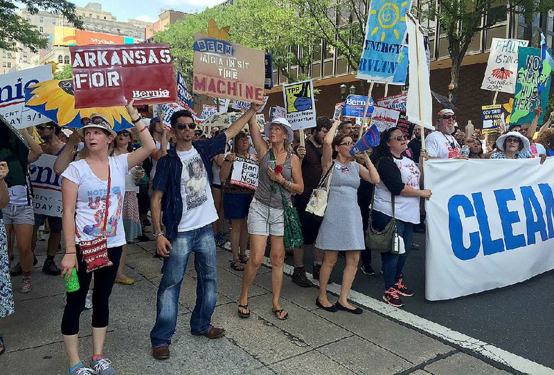 Two Fayetteville-area residents, Heather Jordan (left) and William Alexander (second from left), marched in downtown Philadelphia on Sunday.Thousands of protesters marched to a spot near Independence Hall and the Liberty Bell. Most of the signs focused on green energy, opposition to fracking and pipelines, and global warming.
