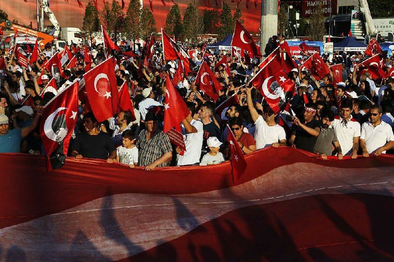 Supporters of the Republican People’s Party wave Turkish flags during a Republic and Democracy Rally at Taksim Square in central Istanbul on Sunday.