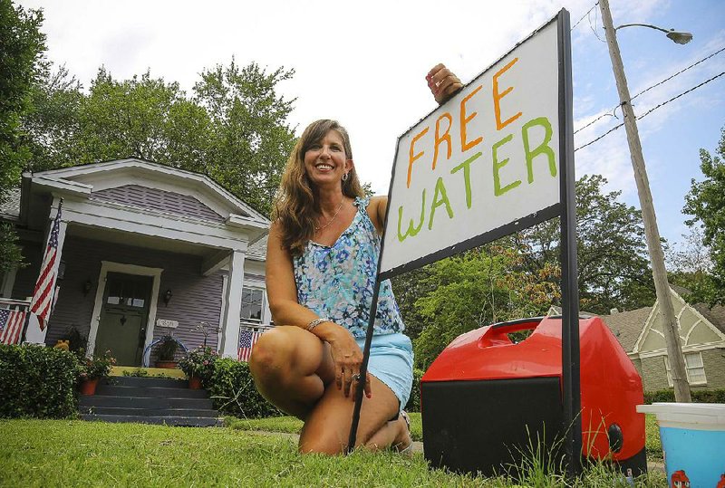 Andrea Cordell has been giving away free water from her front yard at Cantrell Road and Kavanaugh Boulevard for the past five years. 