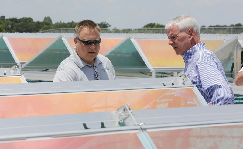 U.S. Rep. Steve Womack (right) listens to Troy Scarbrough, vice president engineering and operations at Ozarks Electric Cooperative, describe the operation of the Ozarks Electric Cooperative O.N.E. Solar Facility during a tour last month in Springdale. The facility has 4,080 solar panels.