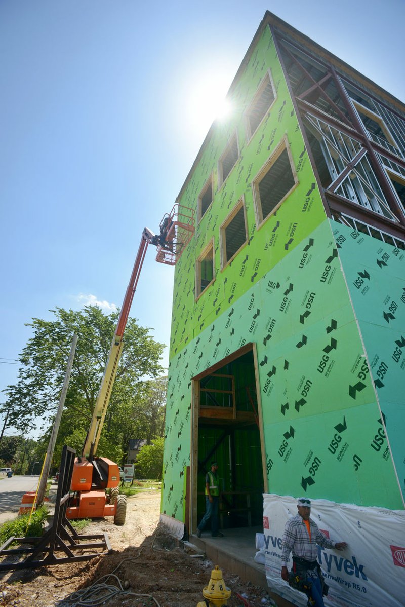 Construction work continues Friday at the new Haxton Road Studios building on Southeast 2nd Street in Bentonville.