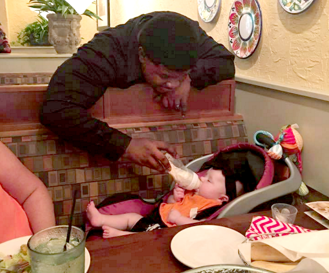 The waiter for Dallas French and her family, who a coworker identified as Robert Davis, feeds French's daughter at Olive Garden while the family took a break to eat on Thursday. The photo was picked up by the "Love What Matters" Facebook page and has been shared more than 6,500 times.  