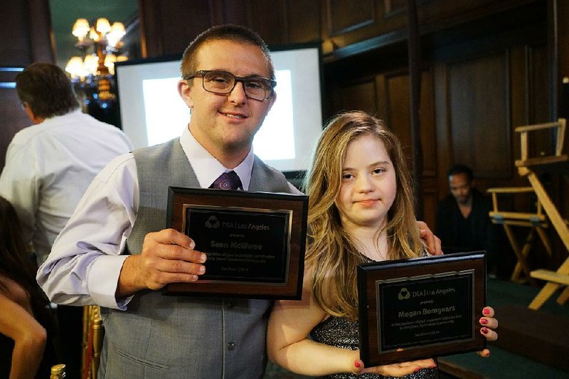 Sean McElwe and Megan Bomgaars display awards from the Los Angeles Down Syndrome Association. The two star in Season 2 of the A&E series Born This Way, starting at 9 p.m. today.