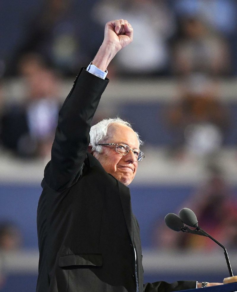 Sen. Bernie Sanders of Vermont raises his fist as he takes the stage Monday at the Democratic National Convention in Philadelphia.