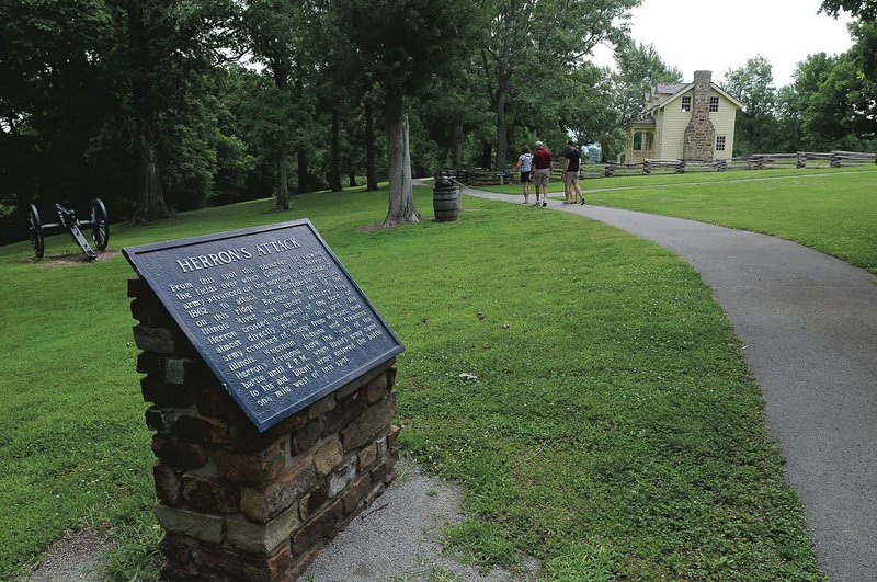 Visitors taking the one-mile walking tour at Prairie Grove Battlefield State Park learn about the Civil War and see natural features and scenic vistas.