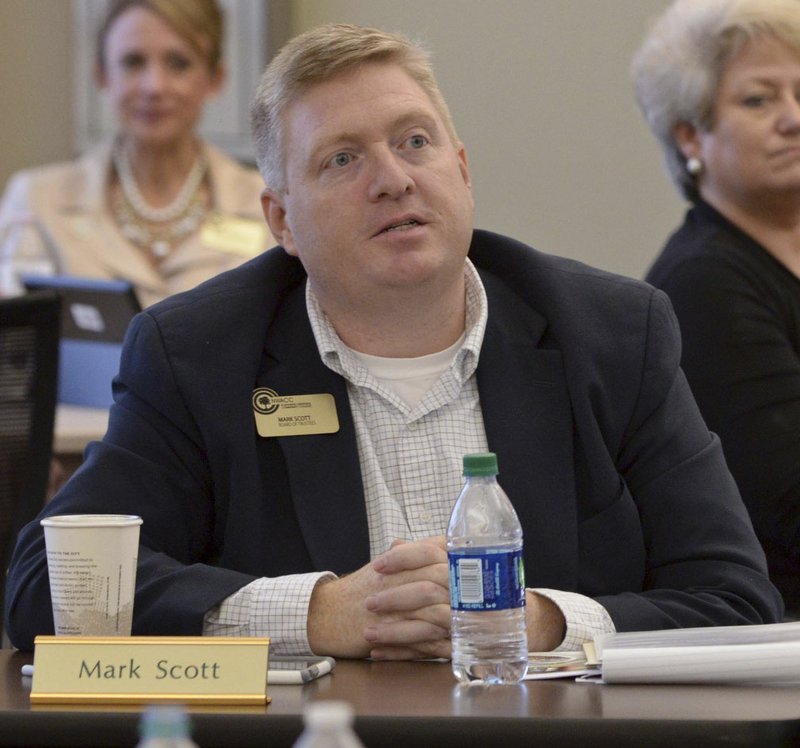 Mark Scott listens to a presentation Saturday during the Northwest Arkansas Community College board retreat in Bentonville. Scott was sworn in as a new member of the board before the meeting.