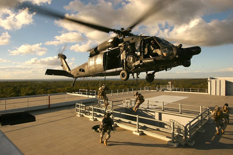 Army Special Operations soldiers descend by rope from an MH-60 helicopter in the 160th Special Operations Aviation Regiment.